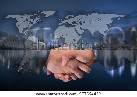 Double Exposure of a businessman handshake on World Global Cartography Globalization ,blue tone Singapore city blurred background.