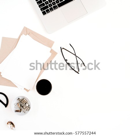 Top view office table desk. Workspace with coffee, craft envelope, scissors, paper blank and laptop on white background. Flat lay.