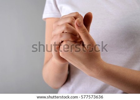 Palms clasped each other. Studio, white background, horizontal close-up Royalty-Free Stock Photo #577573636