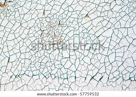 Abstract background of white and green paint chipping off of a cement wall.