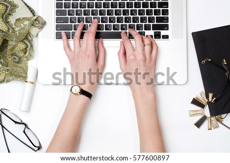 Woman is working on laptop. Workplace. Fashion blog. Flat lay concept photo Royalty-Free Stock Photo #577600897