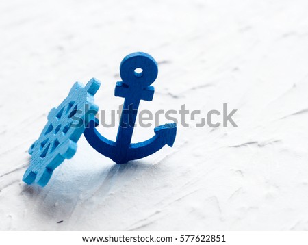Decorative anchor  and marine items on  white wooden background. Sea objects on wooden planks. Selective focus. Place for text.
