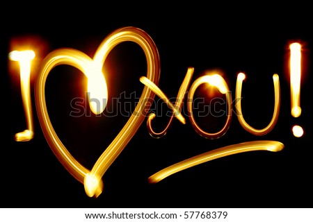 I LOVE YOU phrase created by light over black background