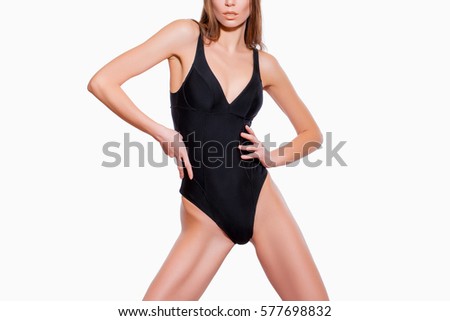 Beautiful Female Body in Black bathing suit on a White Background                 