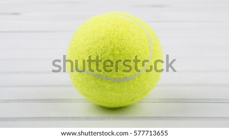 Tennis ball over wooden background