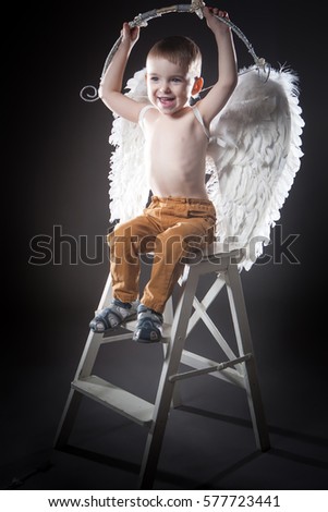 Cupid. Valentine's Day. Boy angel with wings and onion.