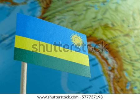 Rwanda flag with a globe map as a background macro