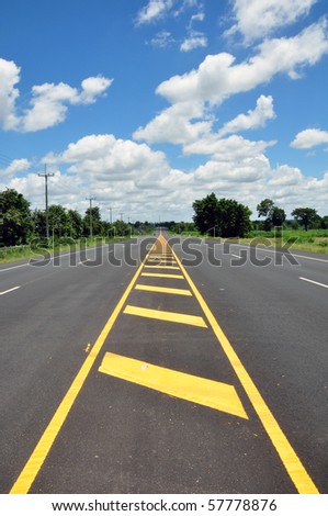 yellow line traffic symbol with asphalt street in blue sky