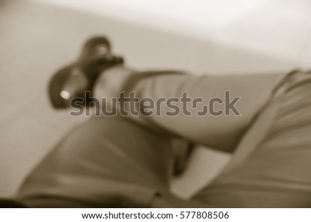 Picture blurred  for background abstract and can be illustration to article of Businessman that cross-legged sit with one's legs crossed