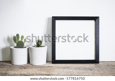 mock up frame with cactus pot on wooden floor Royalty-Free Stock Photo #577816750