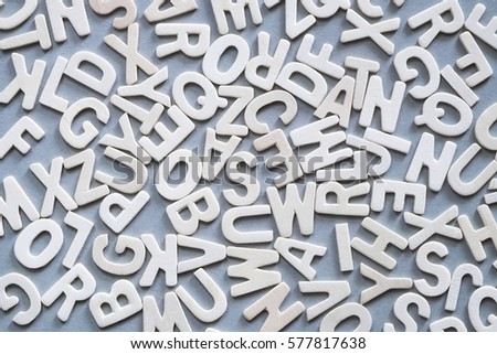 wooden alphabet on grey background