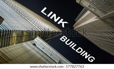 Modern buildings from low angle at night with text link building.