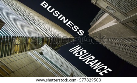 Modern buildings from low angle at night with text business insurance.
