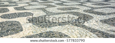 Black and white iconic mosaic, Portuguese pavement by old design pattern at Ipanema beach, Rio de Janeiro, Brazil 