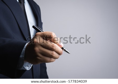 Business man hand holding a pen on white background