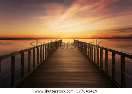 Picture of wooden bridge on calm sea at twilight time