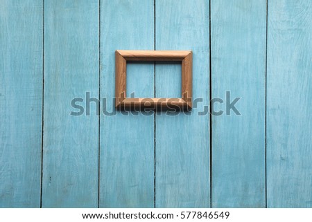old wooden photo frame on blue wooden wall