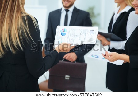 business team with financial documents greets her boss in the of