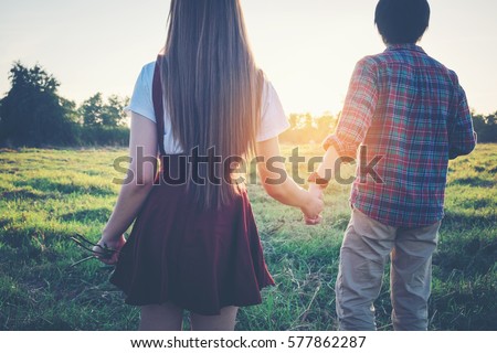 Romantic Couple Boy And Girl Holding Hands With Flower On A White Background Stock Photos And Images Avopix Com