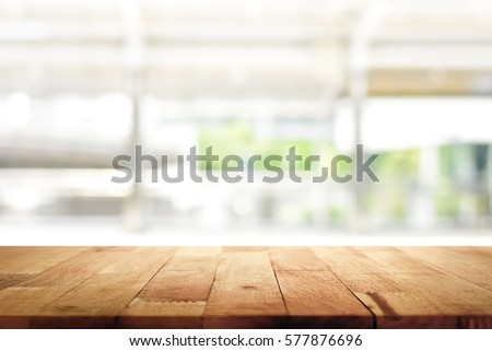 Wood table top on blur kitchen window background - can be used for display or montage your products (or foods)