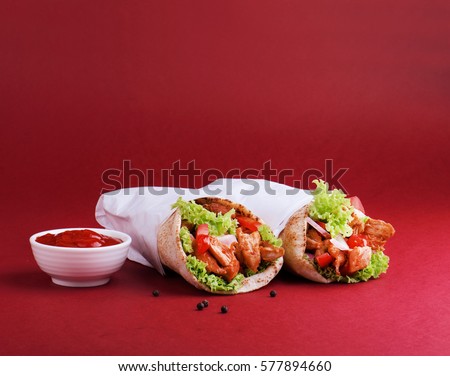 Chicken shawarma with tomato ketchup. Royalty-Free Stock Photo #577894660