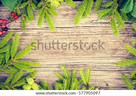 Christmas frame made of fir branches. Christmas wallpaper. Flat lay, top view. Toned photo