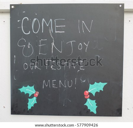 Hand Written Sign "Come In and Enjoy our Festive Menu!" in the Seaside Village of Instow on the North Coast of Devon, England, UK