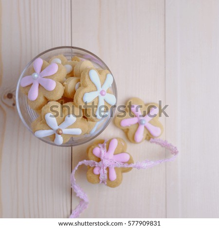Top view of flower cookies in cup on wood table concept, selective focus and copy space.