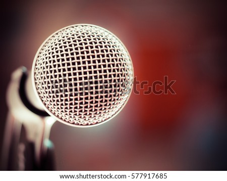 Close up of microphone in karaoke room or conference room. red background (microphone, karaoke, music )