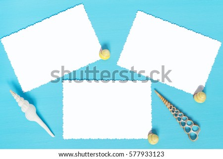 three sheets of white paper on a blue background with shells