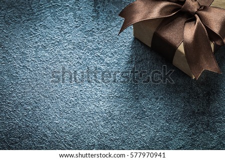Gift box with brown bow on black background celebrations concept.