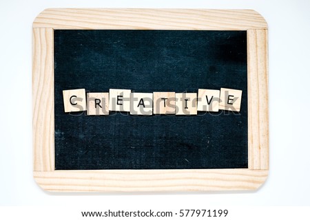 "Creative" in wooden tile letters on chalkboard