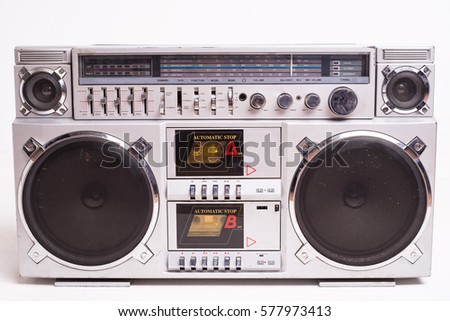 Front View of a Vintage Boom Box Cassette Tape Player Isolated on White Background. Royalty-Free Stock Photo #577973413