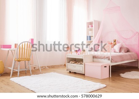 Pink little princess room with canopy bed, desk and chair Royalty-Free Stock Photo #578000629