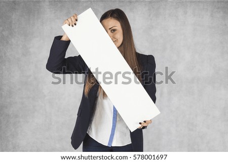 business woman hides behind billboards