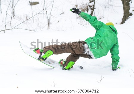 Athletic man snowboarding on ski slope. The concept of a healthy lifestyle, snowboarding.