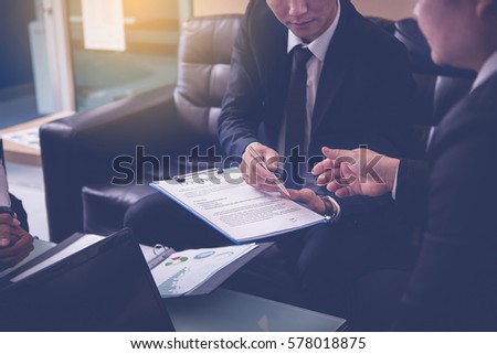 Businessman offering pen to his business partner for sign contract