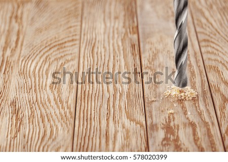 metal drill bit make holes in wooden board with expressive texture