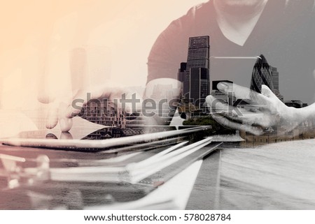 Double exposure of Designer hand using mobile payments online shopping,omni channel,in modern office wooden desk,London city buildings,eyeglass