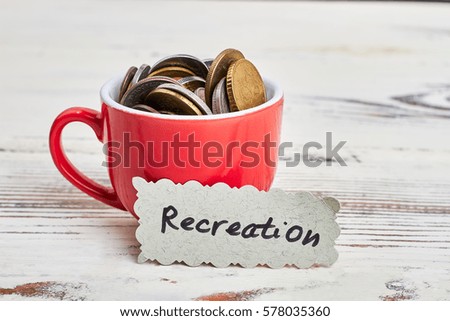 Coins in cup and card. Save money, travel more.