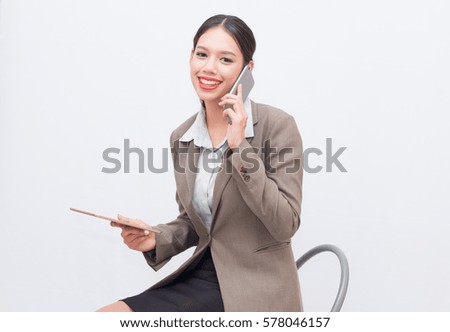 Businesswoman use of mobile phone. young woman used smart phone and tablet.