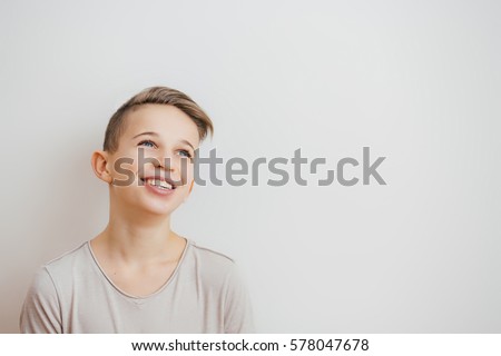 Portrait of a happy  smiling teenager boy looking away 