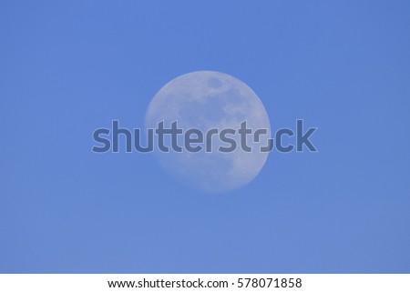 Full moon at clear blue sky at day light