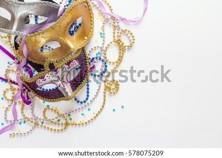 Mardi Gras background with masks, beads and copy space. Carnival mask on a white background. 