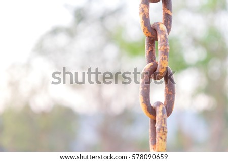 old yellow rust iron chain with blur background.