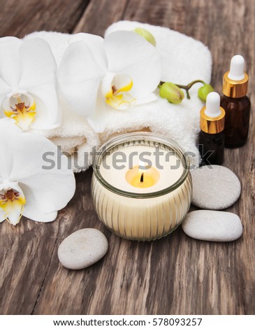 Spa products with white orchids flowers on a table