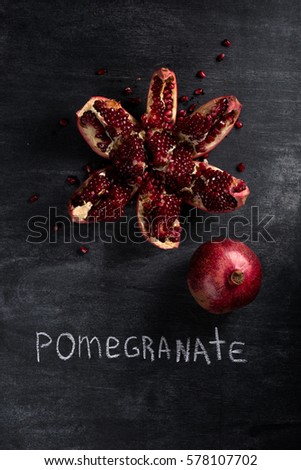 Top view picture of pomegranate over dark chalkboard background
