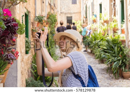 young woman sightseeing and photographing