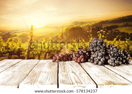 Sunset time and fresh grapes fruits on wooden desk place 