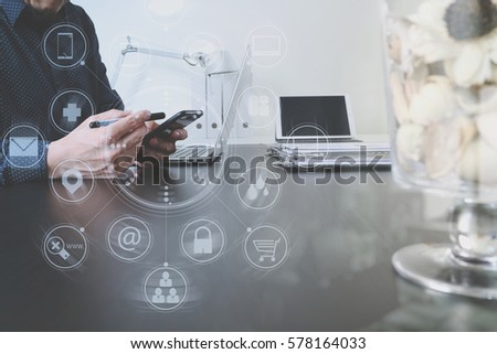 businessman or Designer using smart phone with latop and digital tablet computer in modern office with virtual interface graphic icons network diagram